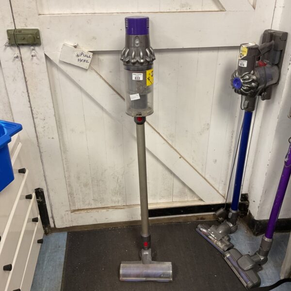 Purple Dyson V8 cordless stick vacuum cleaner in used condition.