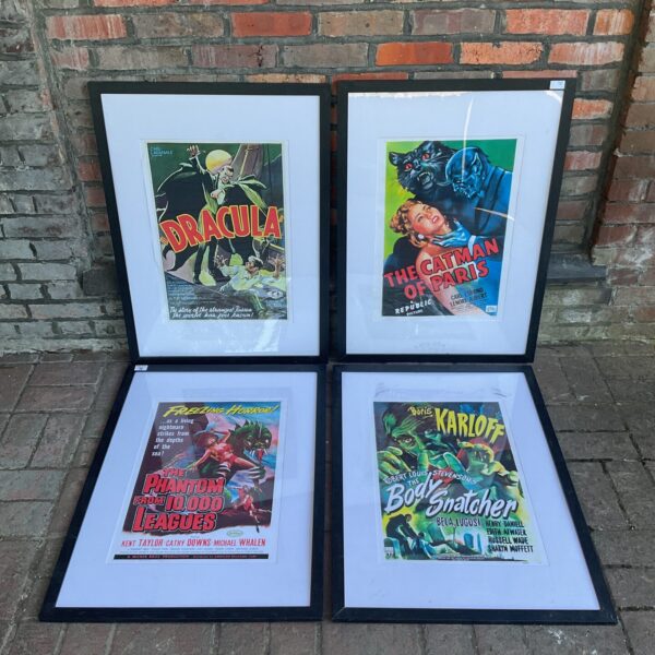 Framed horror movie poster prints including Dracula and The Cat and the Canary.