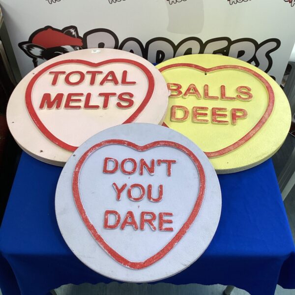 Three adult-themed love hearts with playful phrases.