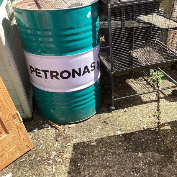 Front view of a vintage Petronas oil drum.