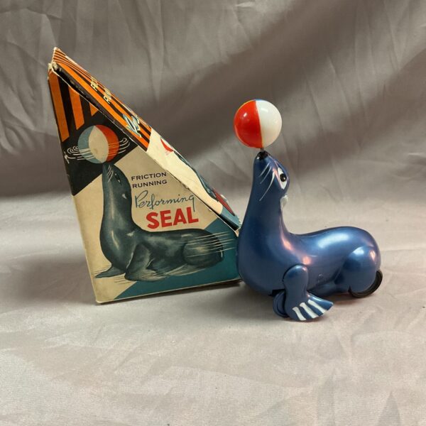 Vintage tin friction seal toy in original box.