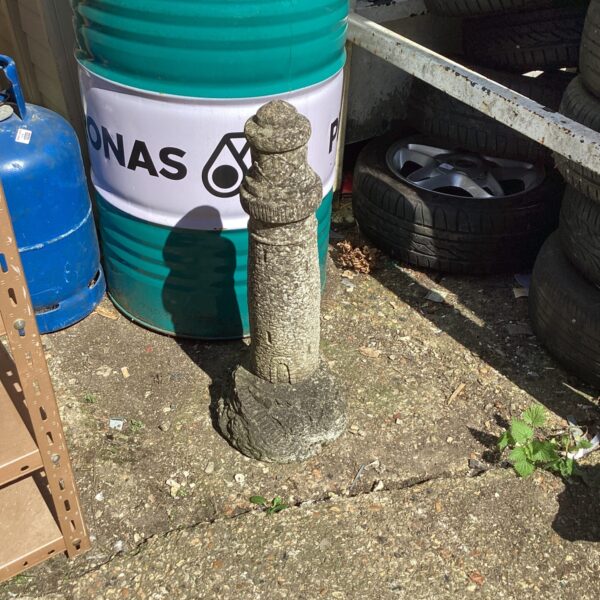 Weathered concrete lighthouse garden ornament for coastal gardens.