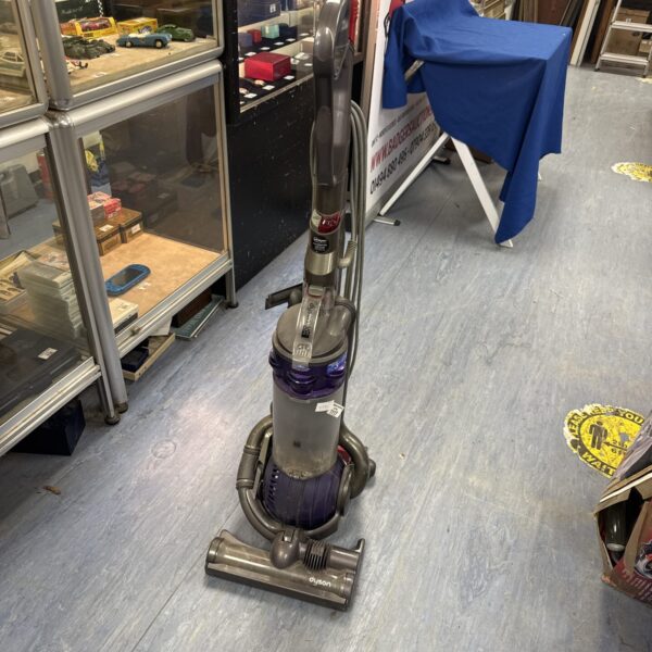 Used Dyson DC25 upright vacuum cleaner in a home setting.