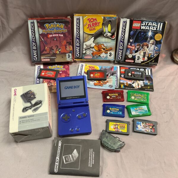 Game Boy Advance bundle with games and power supply for retro gaming.
