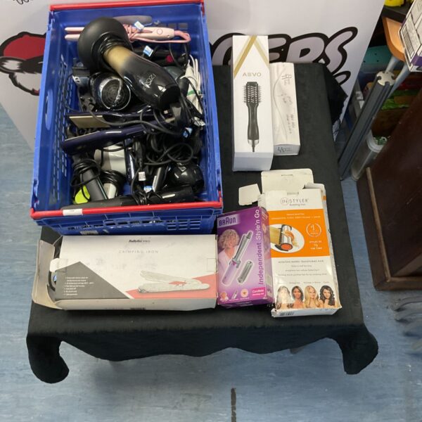 Crate of mixed beauty items including hair curlers and dryers.