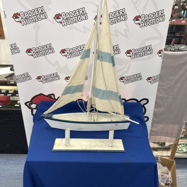 White hull model sailing boat with detailed rigging.