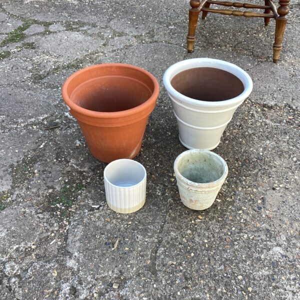Assorted terracotta and ceramic garden plant pots for outdoor use.