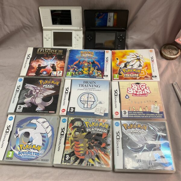 Nintendo DS consoles and game cartridges in a gaming lot.
