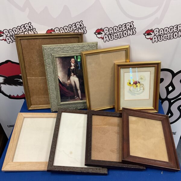 Vintage empty picture frames with carved wood and gilt detailing.