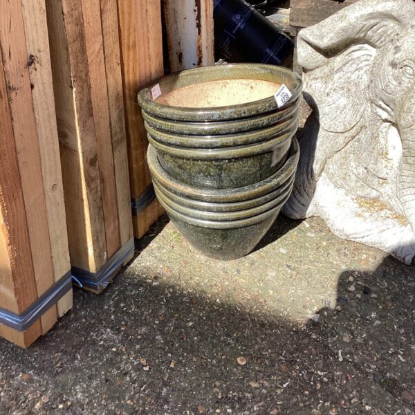 Stacked glazed terracotta garden pots for outdoor planting.