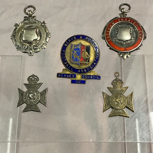Vintage football badges and silver fobs, a collectible sports lot.