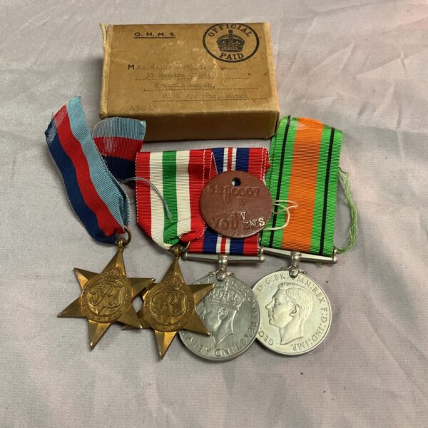 WWII medal group with dog tag and box, collectible military history.