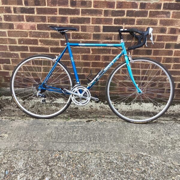 Vintage Peugeot racing bike in blue, classic French road bicycle.