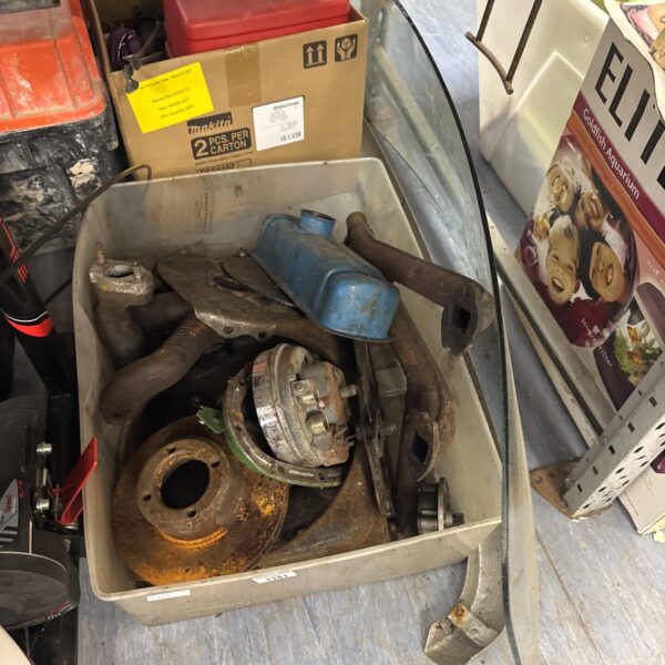 Classic Mini parts lot with windscreen and bumper for restoration.