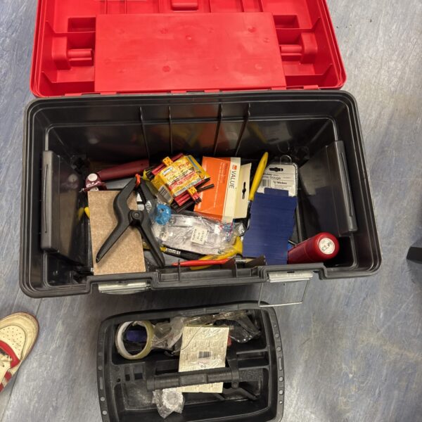 Large plastic toolbox filled with assorted tools and hardware.