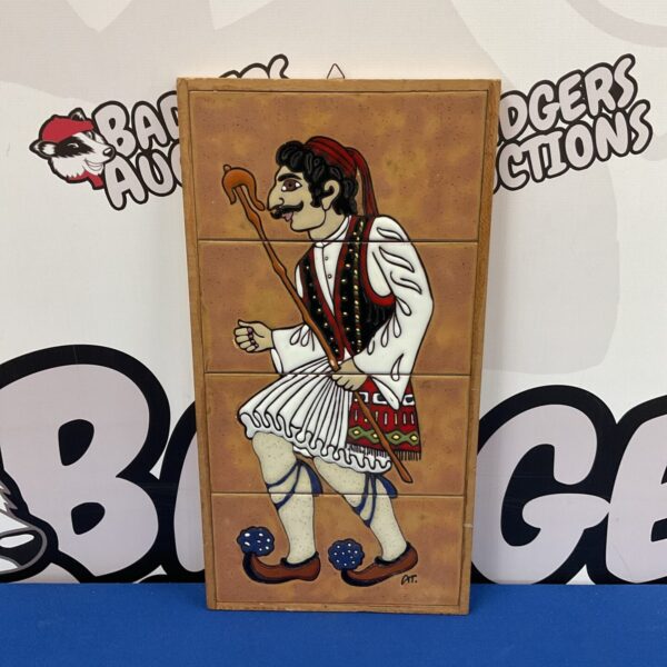 Signed Greek ceramic wall plaque by Angelo Tsakirakis depicting a man in traditional dress.