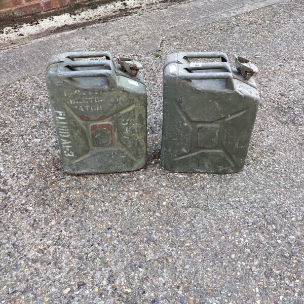 Two vintage metal fuel cans, military surplus, showing signs of wear.
