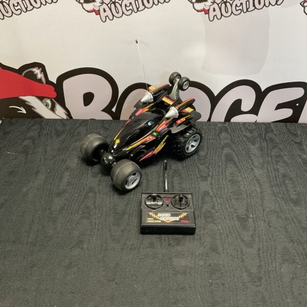 Front view of vintage Explorer Ex-2 RC buggy with remote.