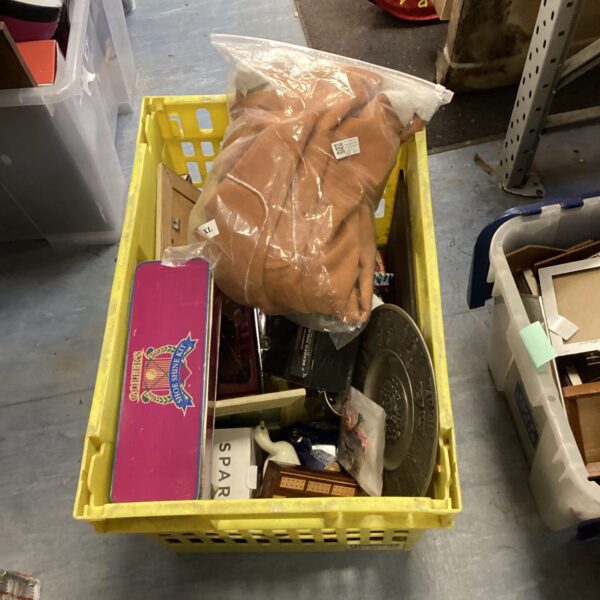 Yellow crate filled with a house clearance lot including vintage clothing.
