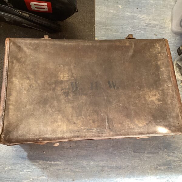 Antique leather travel trunk with W.H.W. initials, vintage luggage.