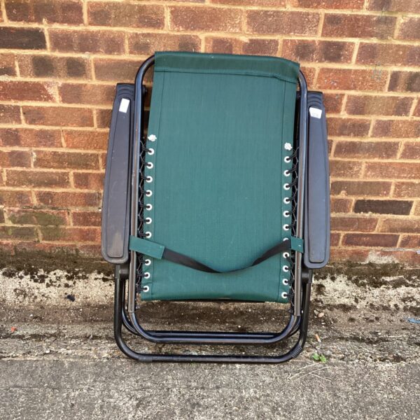 Green garden sunlounger with a folding frame, ideal for outdoor use.