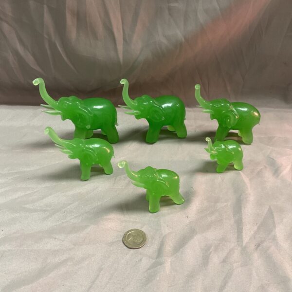 Vintage jadite elephant collection on a neutral background.