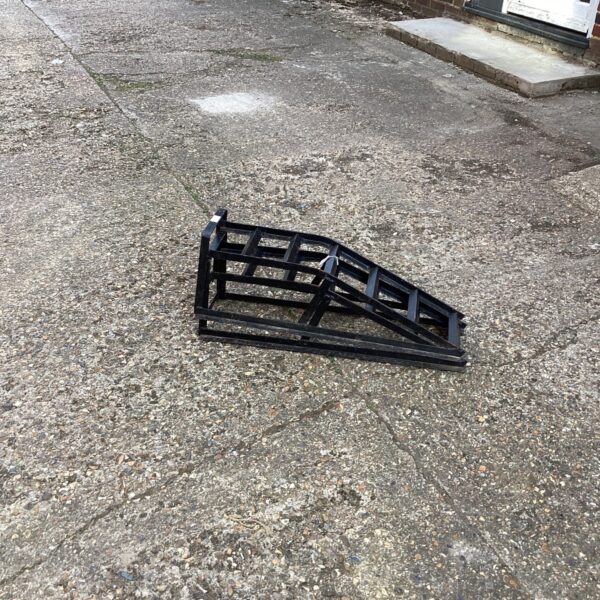 Metal car ramps pair for vehicle maintenance and repair.