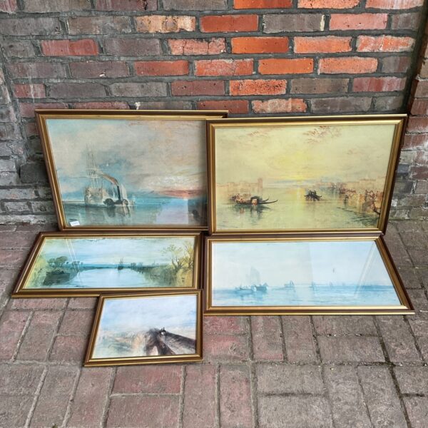 Gilt framed landscape print with coastal scene.