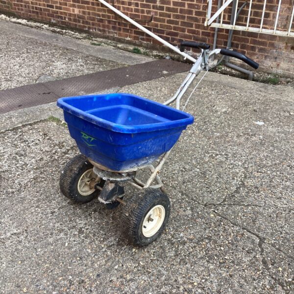 Blue RT garden spreader with wheels for seed and fertilizer distribution.