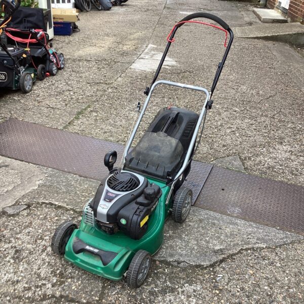 Green Qualcast 450 lawn mower in a garden setting.