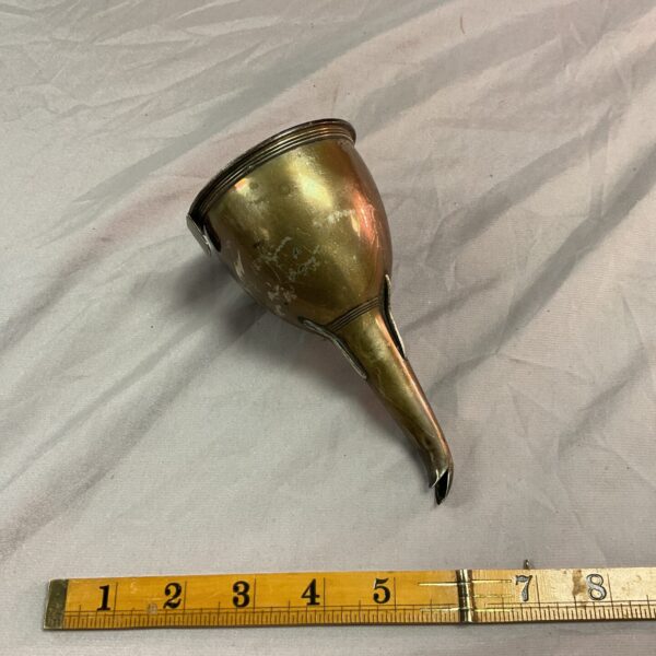 Antique silver wine funnel with ruler for scale.