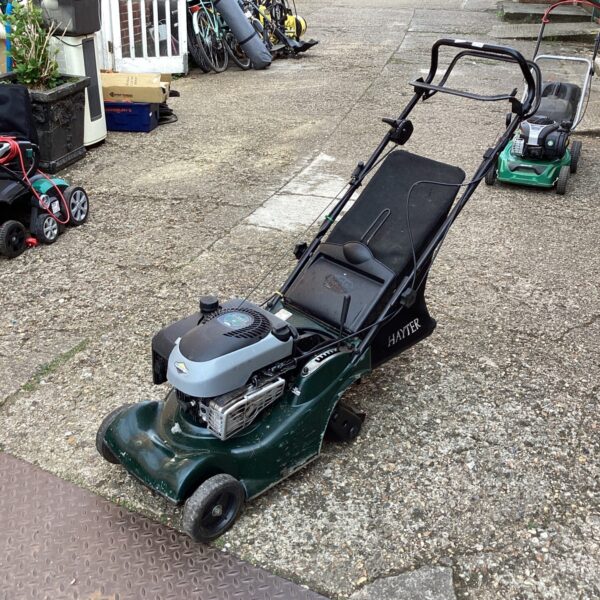 Vintage Hayter 41 petrol lawn mower in a garden setting.