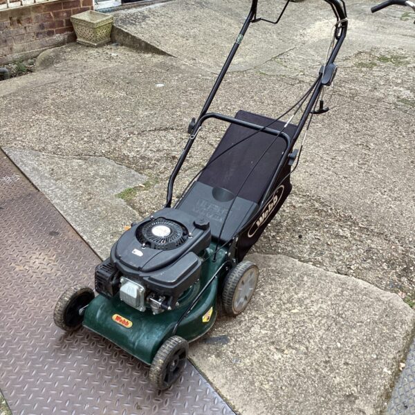 Webb petrol lawn mower in a garden setting.
