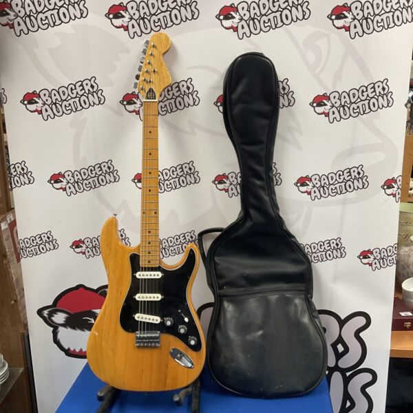 Vintage Kay electric guitar with sunburst finish and hard case.
