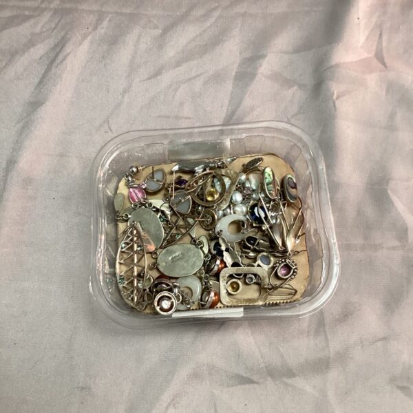 Assortment of vintage costume jewellery including brooches and earrings.