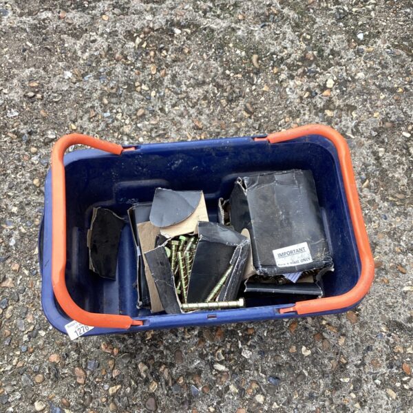 A plastic container filled with various steel anchor bolts.