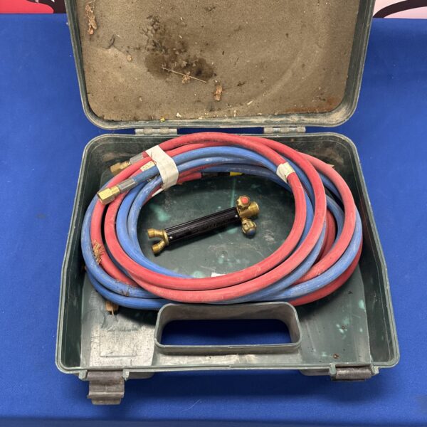 Vintage acetylene torch pipes in red and blue.