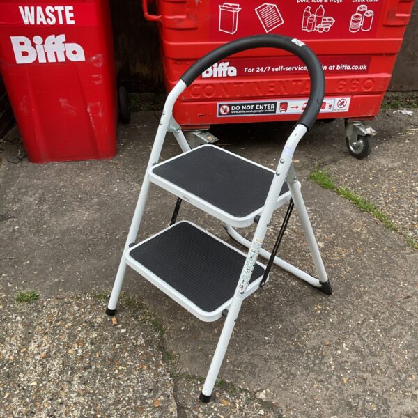 Vintage metal kitchen step stool for household use.