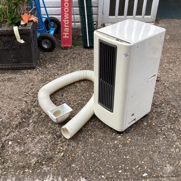 Portable air conditioner unit with flexible hose for cooling.