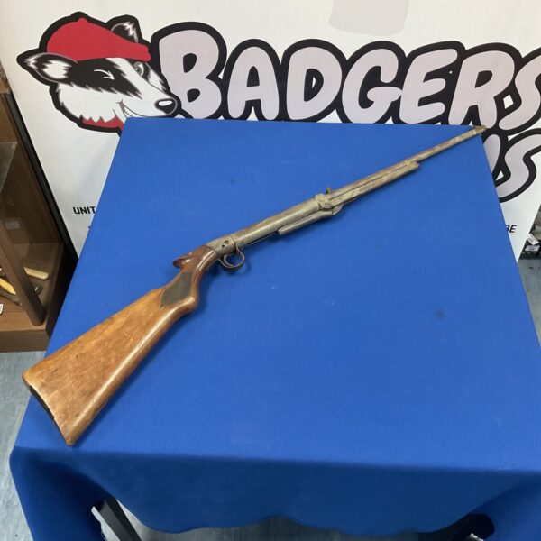 Vintage air rifle side view, antique collectible airgun.