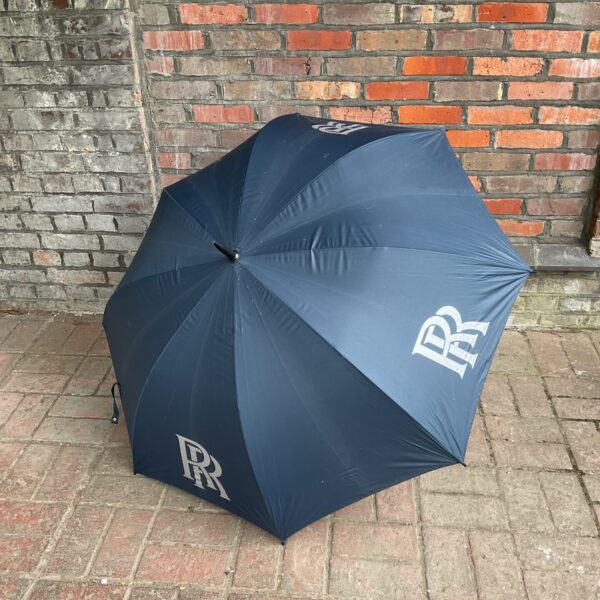 Classic black vintage Rolle Royce umbrella, a luxury accessory.
