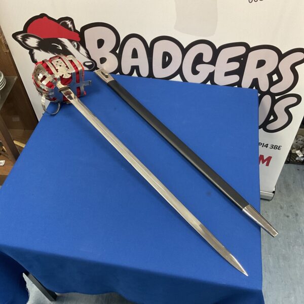 Antique Scottish basket hilt broadsword with intricate detailing.