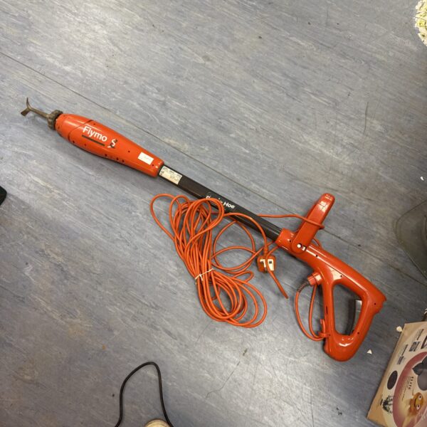 Orange Flymo power hoe for garden maintenance and weed removal.