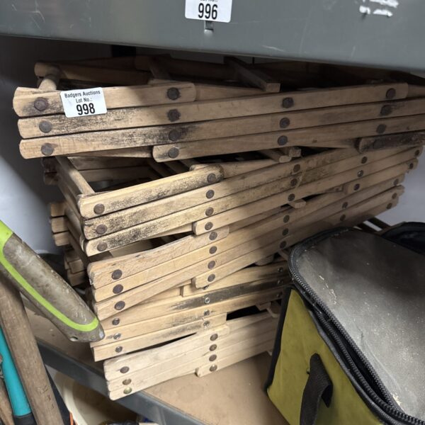 Lot of vintage wooden folding bottle racks for storage.