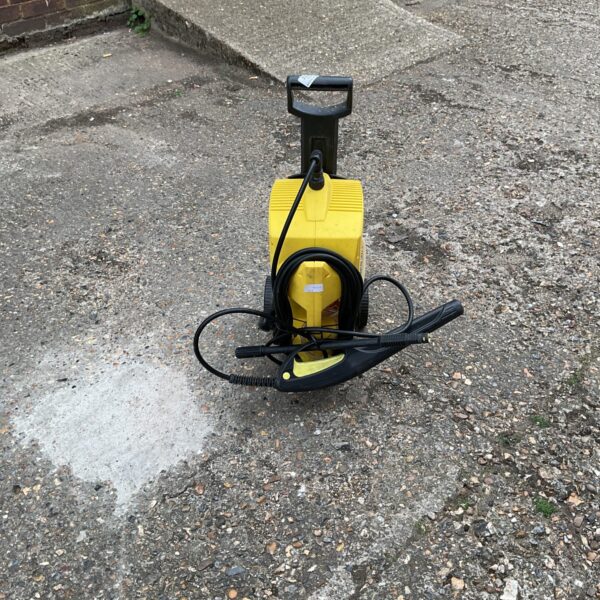 Yellow Karcher 411 A pressure washer for garden and patio cleaning.