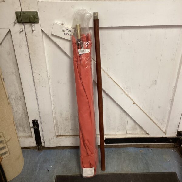 Vintage wooden garden umbrella pole with reddish-brown finish.
