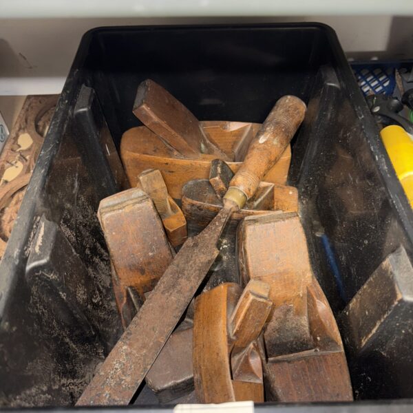 Vintage woodworking tools including hand planes in a lot.