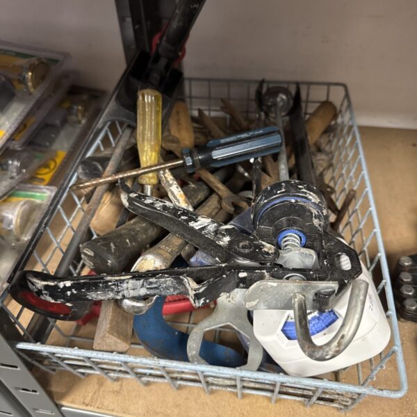 Mixed lot of shed clearance tools including sealant guns and hand tools.
