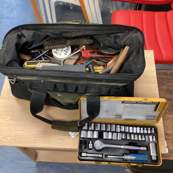 Vintage black tool bag with socket wrench set inside.