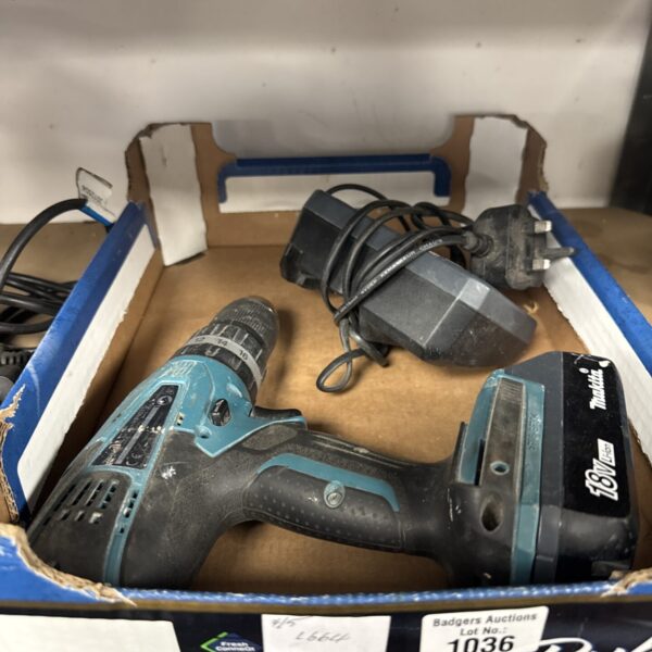 Makita cordless drill with charger, power tool for DIY projects.